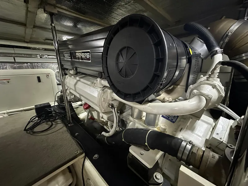 Slide: The Image of Engine room of 2005 Carver 56 Voyager yacht, featuring a powerful diesel engine. - 28