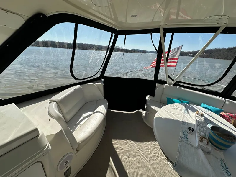 Slide: The Image of Interior of 2005 Carver 56 Voyager yacht with lake view and American flag. - 9