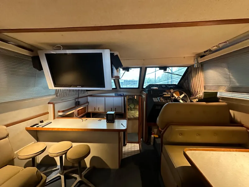 Slide: The Image of Interior of 1991 Sea Ray 380 Aft Cabin yacht with TV and seating area. - 10
