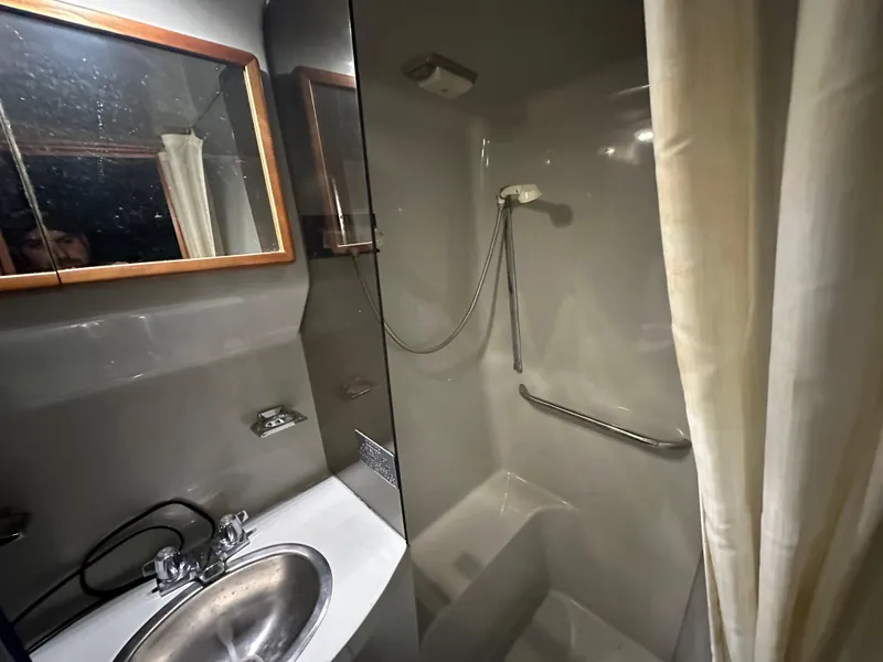 Slide: The Image of 1991 Sea Ray 380 Aft Cabin bathroom with sink, mirror, and shower. - 14