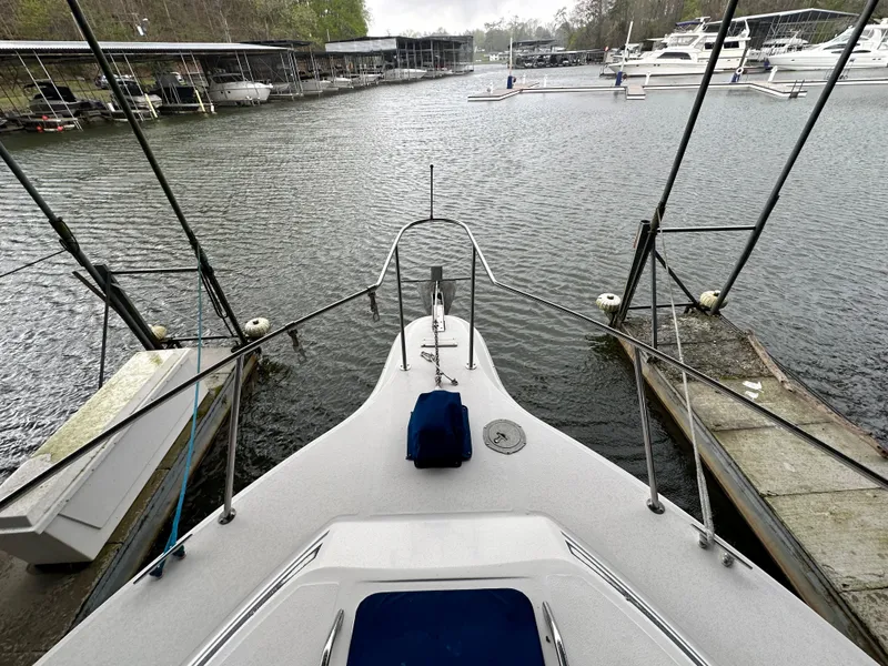 Slide: The Image of 1991 Sea Ray 380 Aft Cabin docked at a marina, view from the bow. - 18