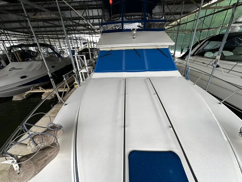 Slide: The Image of 1991 Sea Ray 380 Aft Cabin yacht docked in a marina. - 19