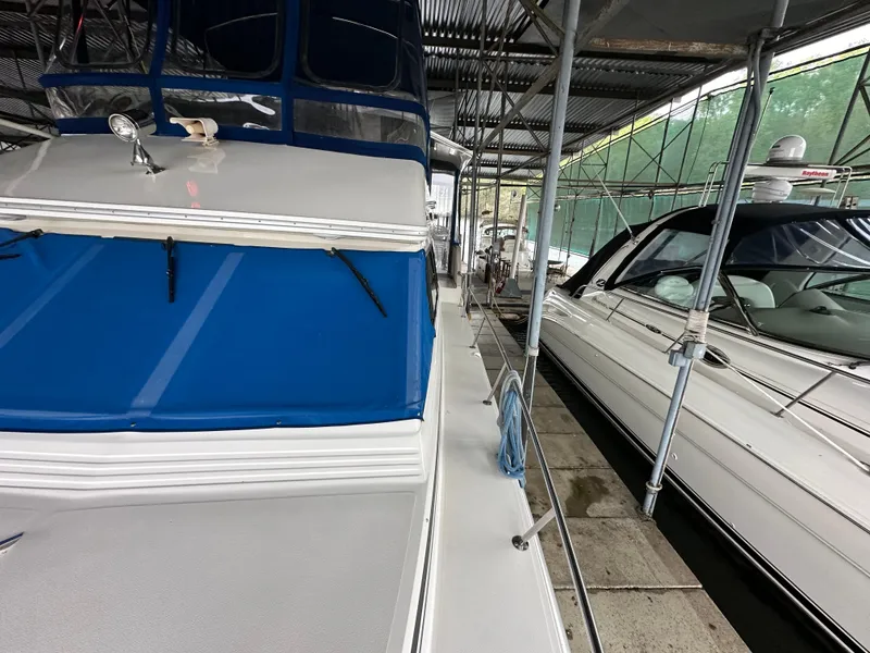 Slide: The Image of 1991 Sea Ray 380 Aft Cabin yacht docked in a marina. - 20