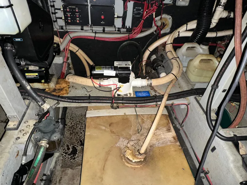 Slide: The Image of Engine room of a 1991 Sea Ray 380 Aft Cabin boat with wiring and hoses. - 23