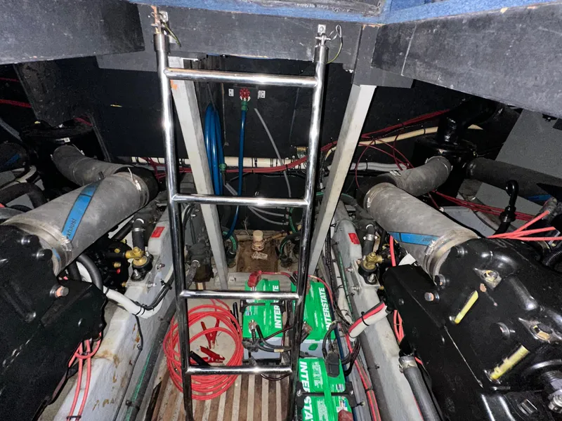 Slide: The Image of Engine room of a 1991 Sea Ray 380 Aft Cabin yacht with visible batteries and wiring. - 24