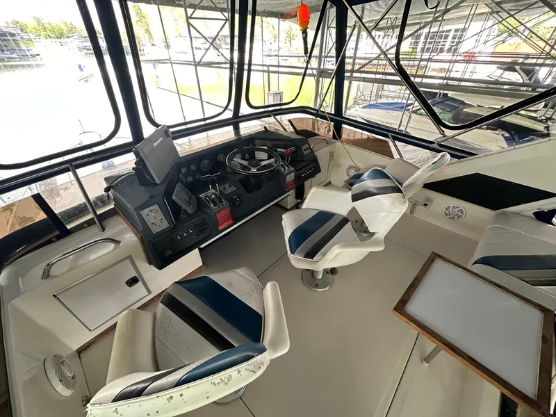 Slide: The Image of 1991 Sea Ray 380 Aft Cabin helm with seating and navigation equipment. - 3
