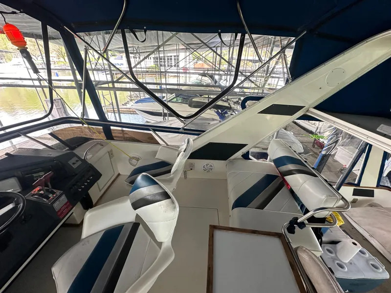 Slide: The Image of 1991 Sea Ray 380 Aft Cabin boat interior with helm and seating area. - 4