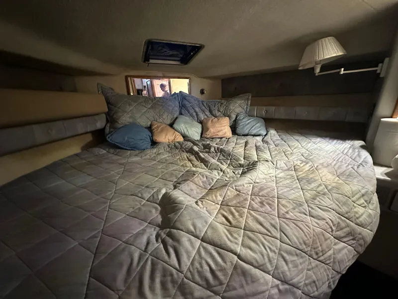 Slide: The Image of Cozy bedroom in 1991 Sea Ray 380 Aft Cabin yacht with quilted bedding. - 5