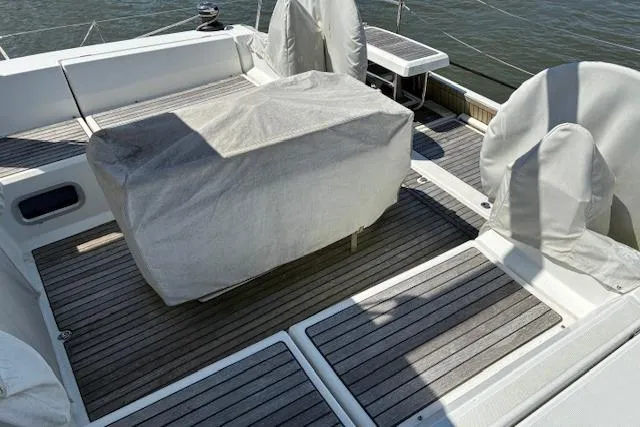 Slide: The Image of 2017 Beneteau Oceanis 41.1 yacht deck with covered seating and wooden flooring. - 15