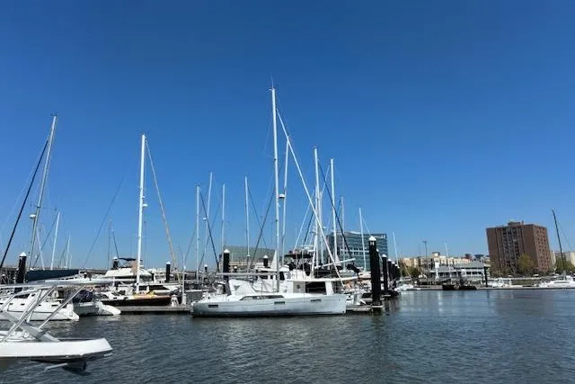 Slide: The Image of 2017 Beneteau Oceanis 41.1 sailboat docked in a marina under clear blue skies. - 21