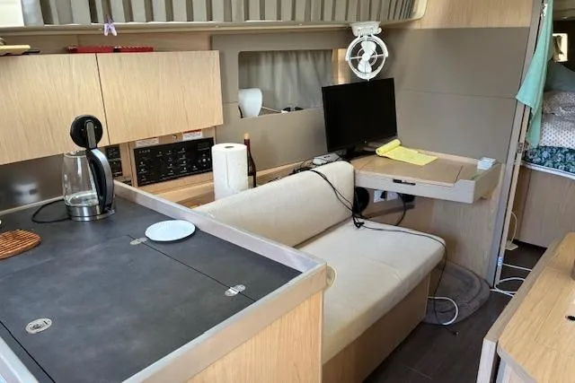 Slide: The Image of Interior of 2017 Beneteau Oceanis 41.1 yacht with modern kitchen and seating area. - 26