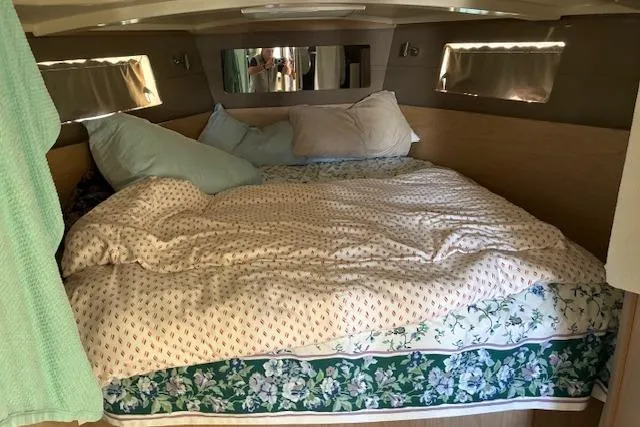 Slide: The Image of Cozy cabin bedroom in a 2017 Beneteau Oceanis 41.1 yacht with plush bedding. - 27