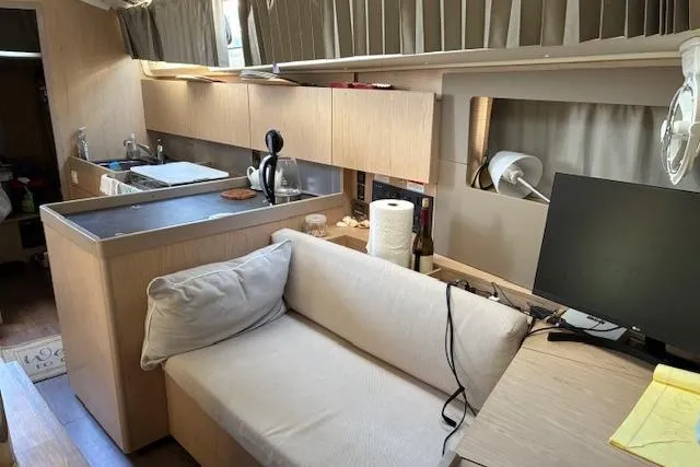 Slide: The Image of Interior of 2017 Beneteau Oceanis 41.1 yacht with modern kitchen and cozy seating area. - 28