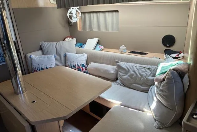 Slide: The Image of Cozy interior of 2017 Beneteau Oceanis 41.1 sailboat with cushioned seating and table. - 30