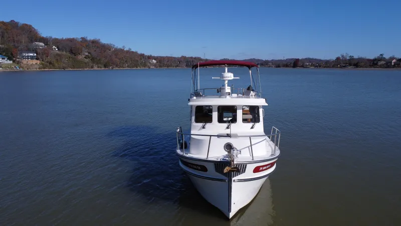Slide: The Image of 2007 Nordic Tug 32 on calm lake with clear blue sky. - 1