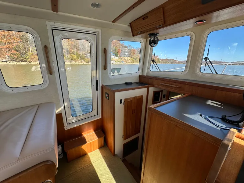 Slide: The Image of Interior of 2007 Nordic Tug 32 with wood finish and scenic water view. - 10