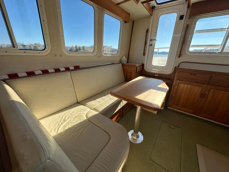 Slide: The Image of Cozy interior of 2007 Nordic Tug 32 with seating and table. - 15
