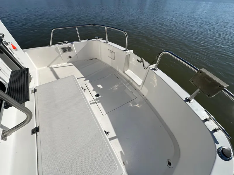 Slide: The Image of 2007 Nordic Tug 32 boat deck with seating, overlooking calm water. - 18