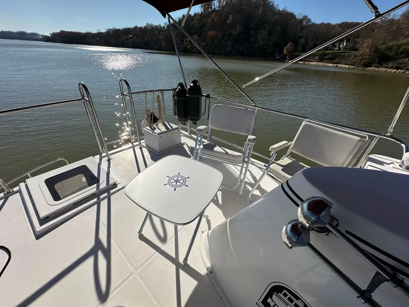 Slide: The Image of 2007 Nordic Tug 32 boat deck with chairs and table on a sunny day. - 20