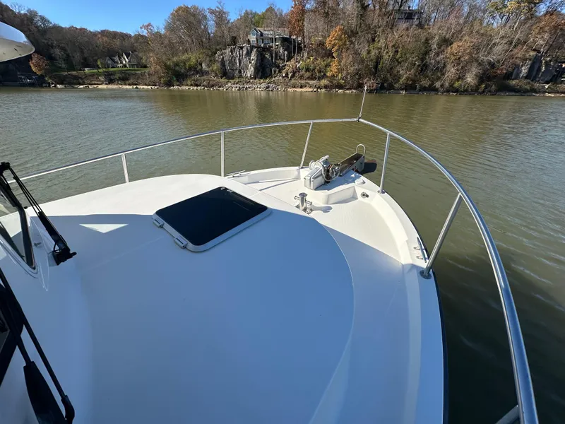 Slide: The Image of 2007 Nordic Tug 32 on calm river, surrounded by autumn trees. - 22