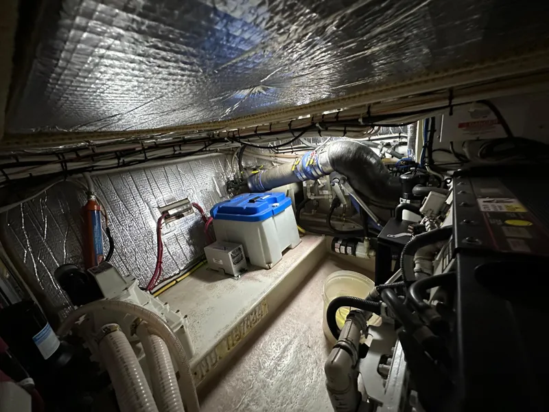 Slide: The Image of Engine room of a 2007 Nordic Tug 32, featuring insulated walls and mechanical components. - 25