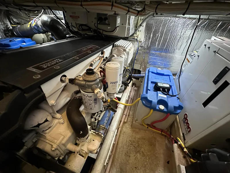 Slide: The Image of Engine room of 2007 Nordic Tug 32, showcasing mechanical components and wiring. - 26