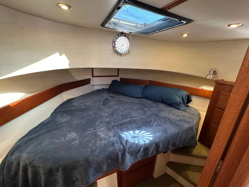 Slide: The Image of Cozy cabin interior of 2007 Nordic Tug 32 with skylight and plush bedding. - 4