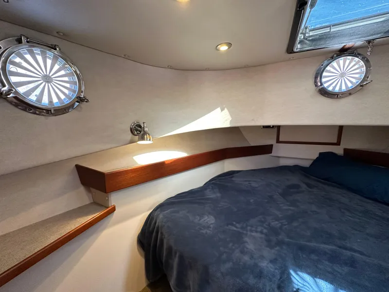 Slide: The Image of Cozy cabin interior of 2007 Nordic Tug 32 with portholes and bed. - 5
