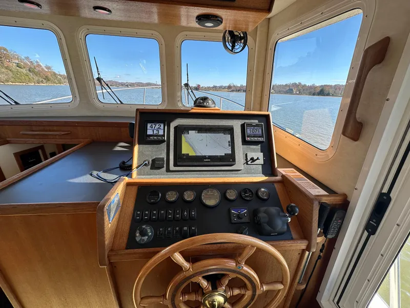 Slide: The Image of 2007 Nordic Tug 32 helm with navigation equipment and scenic water view. - 8