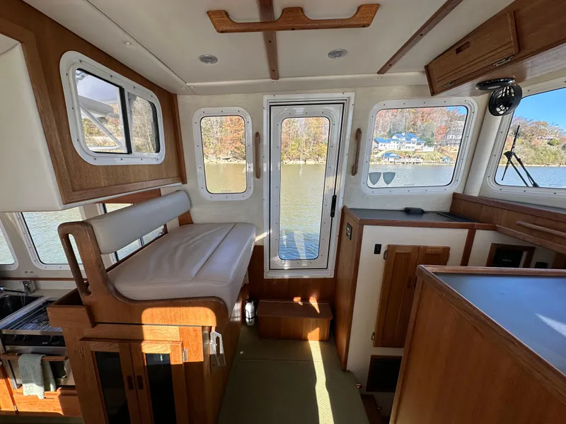 Slide: The Image of Interior of 2007 Nordic Tug 32 with wood accents and large windows. - 9