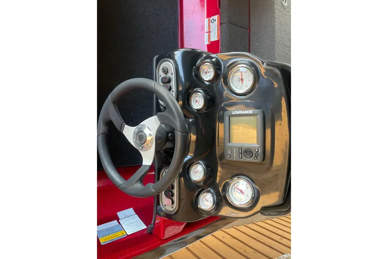 Slide: The Image of Dashboard of a 2013 Nitro Z-7 boat featuring gauges and a Lowrance display. - 10