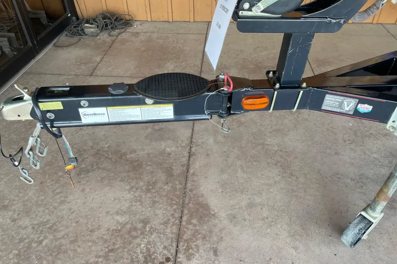 Slide: The Image of Trailer hitch of a 2013 Nitro Z-7 boat, featuring safety chains and wiring. - 6