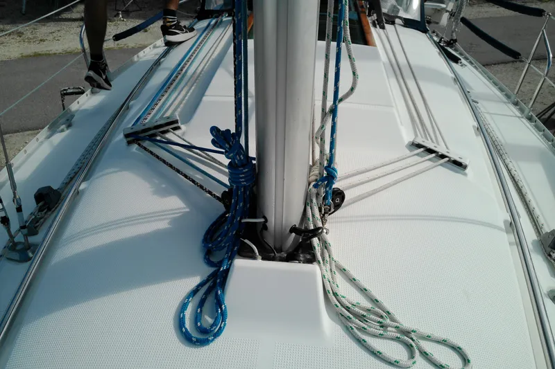 Slide: The Image of Deck view of a 1993 Beneteau First 310 sailboat with rigging and ropes. - 11