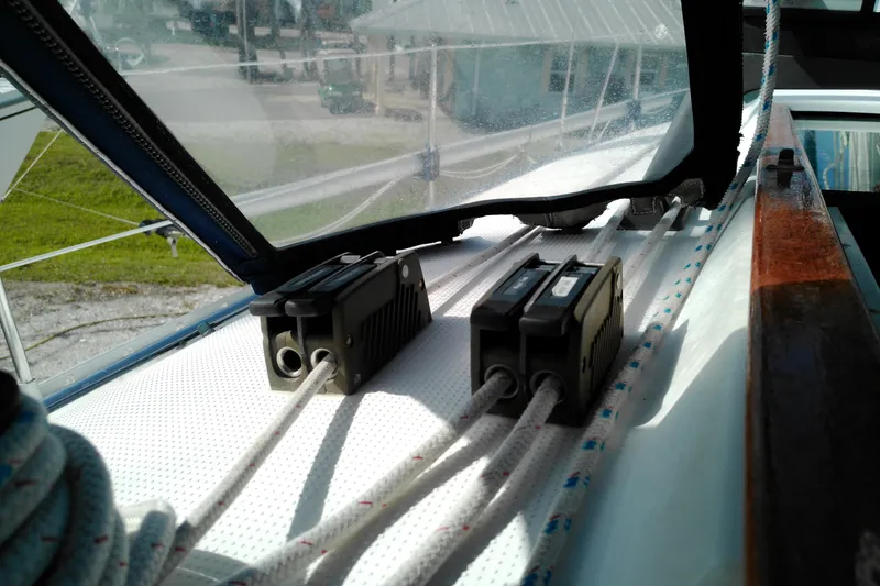 Slide: The Image of Close-up of Beneteau First 310 sailboat deck, showcasing rope clutches and rigging, 1993 model. - 20