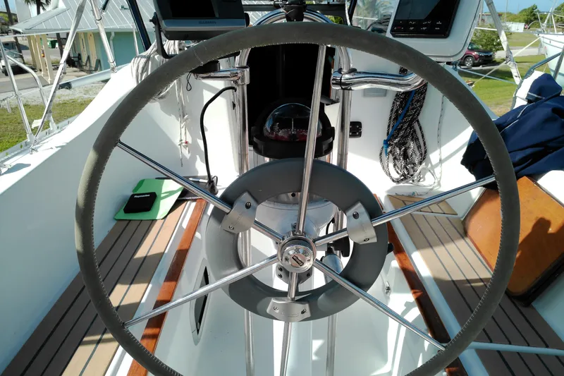 Slide: The Image of Steering wheel of a 1993 Beneteau First 310 sailboat, showcasing cockpit details. - 25