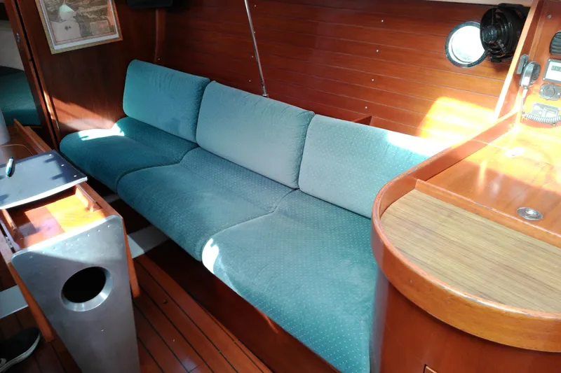 Slide: The Image of Interior of 1993 Beneteau First 310 sailboat with teal sofa and wooden finishes. - 29