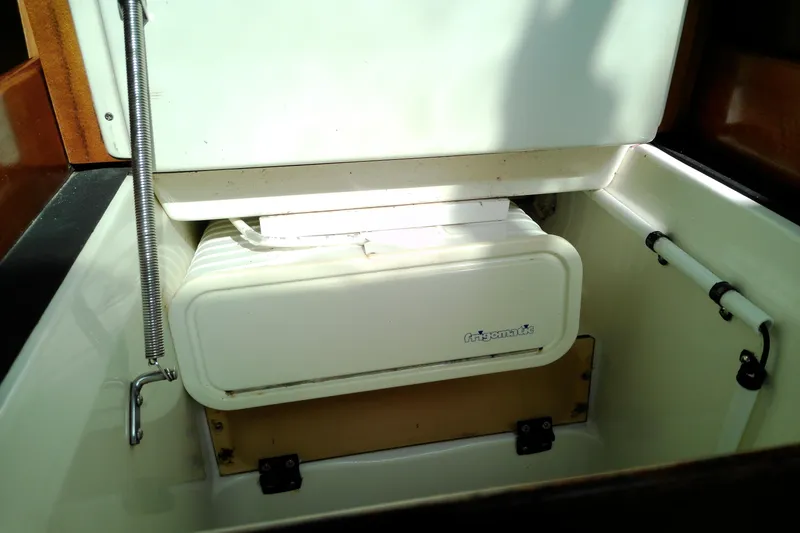 Slide: The Image of Interior view of a 1993 Beneteau First 310 sailboat featuring a Frigomatic refrigeration unit. - 37