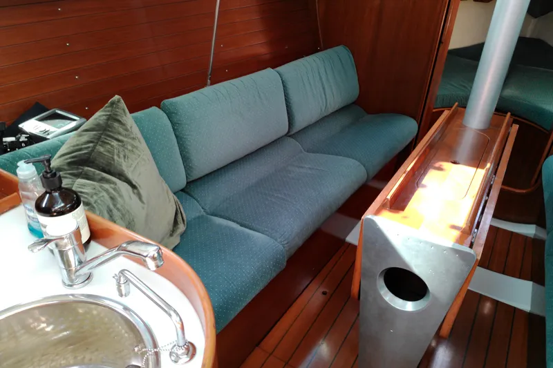 Slide: The Image of Interior of a 1993 Beneteau First 310 sailboat with cozy seating and wooden finishes. - 41
