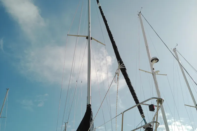 Slide: The Image of Masts of a 1993 Beneteau First 310 sailboat against a clear blue sky. - 7