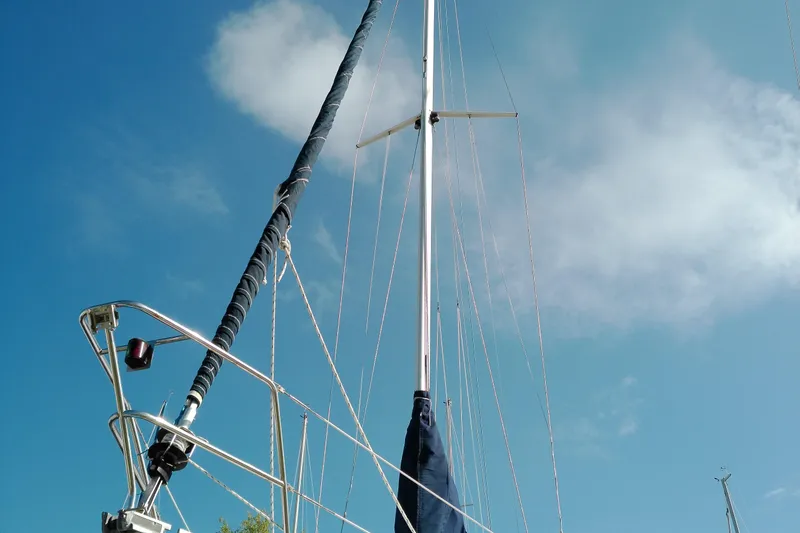Slide: The Image of Mast and rigging of a 1993 Beneteau First 310 sailboat against a clear blue sky. - 8