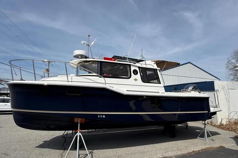 The Image of 2026 Ranger Tugs R-25 boat displayed outdoors on stands. - 1