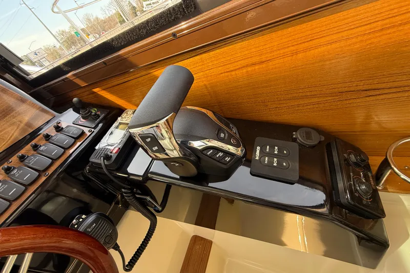 Slide: The Image of Control panel of 2026 Ranger Tugs R-25 boat with throttle and switches. - 13