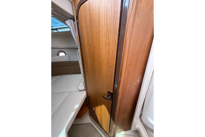 Slide: The Image of Interior cabin of 2026 Ranger Tugs R-25 with wooden door and cozy seating. - 18