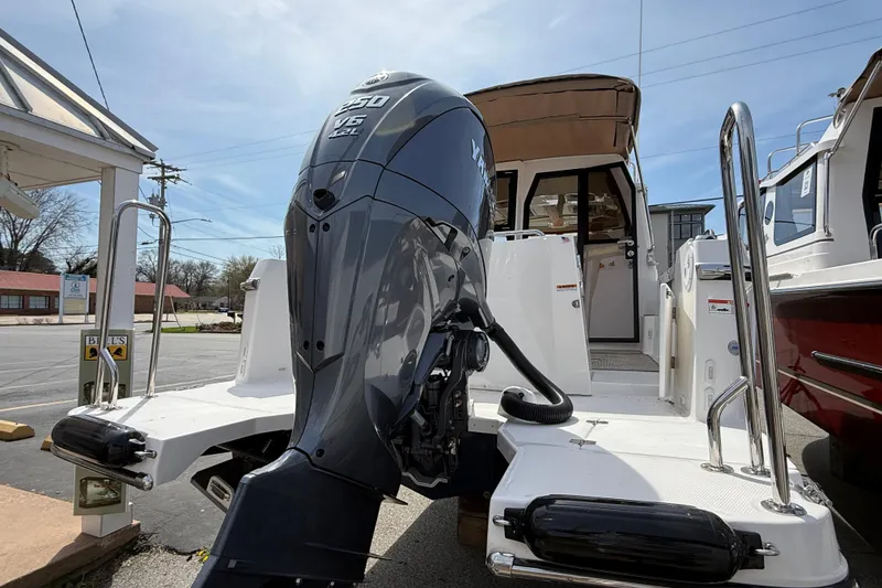 Slide: The Image of 2026 Ranger Tugs R-25 boat with Yamaha V6 outboard motor, docked outdoors. - 6