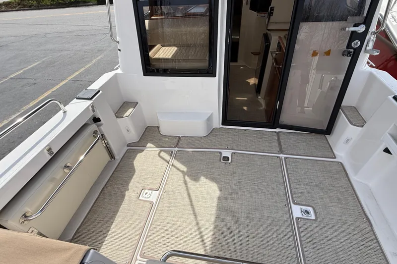 Slide: The Image of 2026 Ranger Tugs R-25 boat deck with open cabin door, showcasing interior. - 7