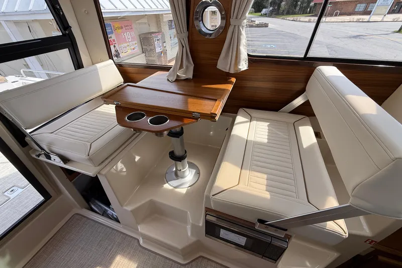 Slide: The Image of Interior of 2026 Ranger Tugs R-25 with seating and wooden table. - 9