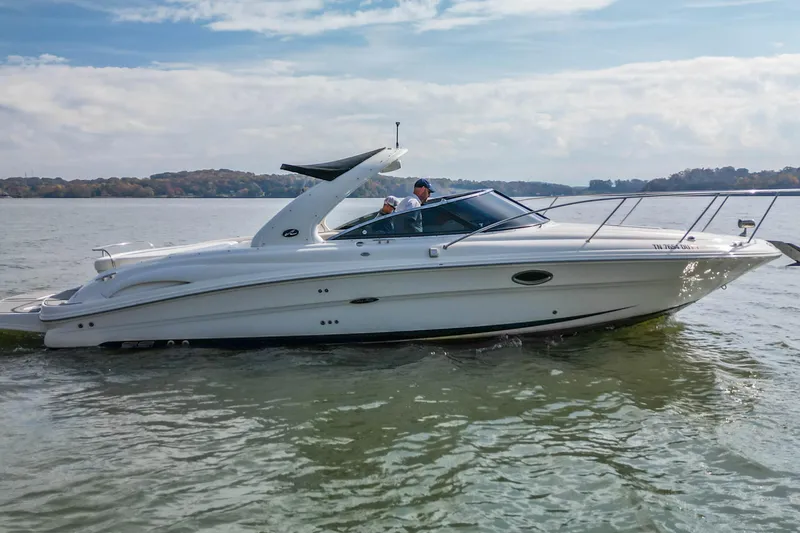 Slide: The Image of 2007 Sea Ray 290 Sun Sport boat cruising on a calm lake. - 1