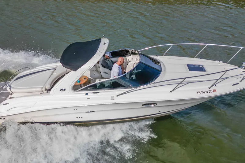 Slide: The Image of 2007 Sea Ray 290 Sun Sport cruising on water, side view. - 7