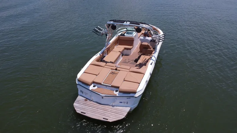 Slide: The Image of 2021 MasterCraft XT25 boat on water, aerial view. - 6