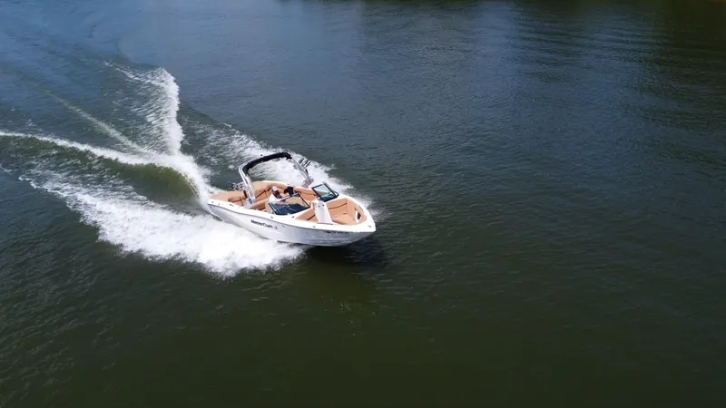 Slide: The Image of 2021 MasterCraft XT25 boat cruising on a lake. - 9